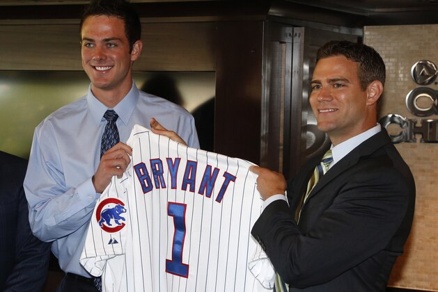 Chicago Cubs president of baseball operations Theo Epstein, right, poses with first-round draft pick, third baseman Kris Bryant during a news conference before a baseball game between the Chicago Cubs and the St. Louis Cardinals Friday, July 12 2013, in Chicago. (AP Photo/Charles Rex Arbogast)