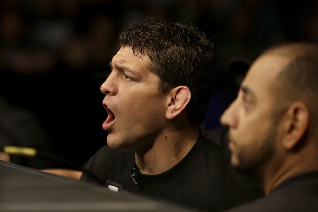 Nick Diaz, left, cheers on his brother Nate Diaz during a UFC lightweight mixed martial arts fight between Nate Diaz and Josh Thomson in San Jose, Calif., Saturday, April 20, 2013. Thomson won by technical knock out in the second round. (AP Photo/Jeff Chiu)