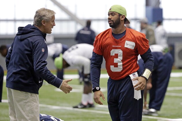 Seattle Seahawks head coach Pete Carroll, left, talks with quarterback Russell Wilson in practice Wednesday, Jan. 21, 2015, in Renton, Wash. The Seahawks play the New England Patriots in the Super Bowl Feb. 1 in Glendale, Ariz. (AP Photo/Elaine Thompson)