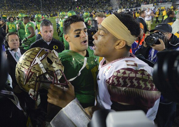 Oregon quarterback Marcus Mariota, center left, greets Florida State quarterback Jameis Winston after Oregon's win in the Rose Bowl NCAA college football playoff semifinal, Thursday, Jan. 1, 2015, in Pasadena, Calif. (AP Photo/Mark J. Terrill)
