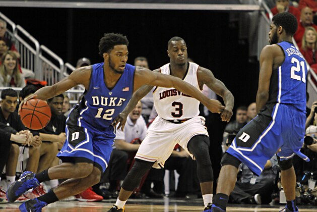 Duke guard Justise Winslow (12) prepares to use a screen by teammate Amile Jefferson (21) to lose Louisville defender Chris Jone s (3) in their NCAA college basketball game in Louisville, Ky., Saturday, Jan. 17, 2014. (AP Photo/Garry Jones)