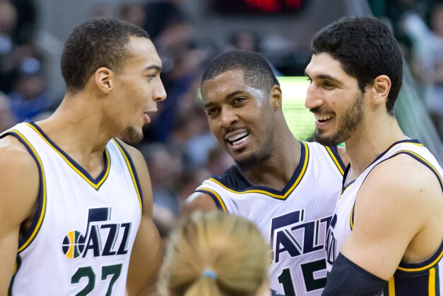 Dec 9, 2014; Salt Lake City, UT, USA; Utah Jazz center Rudy Gobert (27), forward Derrick Favors (15), and center Enes Kanter (R) talk during their game against the San Antonio Spurs at EnergySolutions Arena. Mandatory Credit: Russ Isabella-USA TODAY Sports