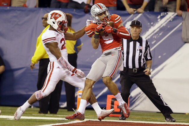 Ohio State wide receiver Devin Smith, right, catches a 42-yard pass for a touchdown as Wisconsin cornerback Peniel Jean defends during the second half of the Big Ten Conference championship NCAA college football game Saturday, Dec. 6, 2014, in Indianapolis. (AP Photo/Michael Conroy) Ohio State wide receiver Devin Smith, right, catches a 42-yard pass for a touchdown as Wisconsin cornerback Peniel Jean defends during the second half of the Big Ten Conference championship NCAA college football game Saturday, Dec. 6, 2014, in Indianapolis. (AP Photo/Michael Conroy)