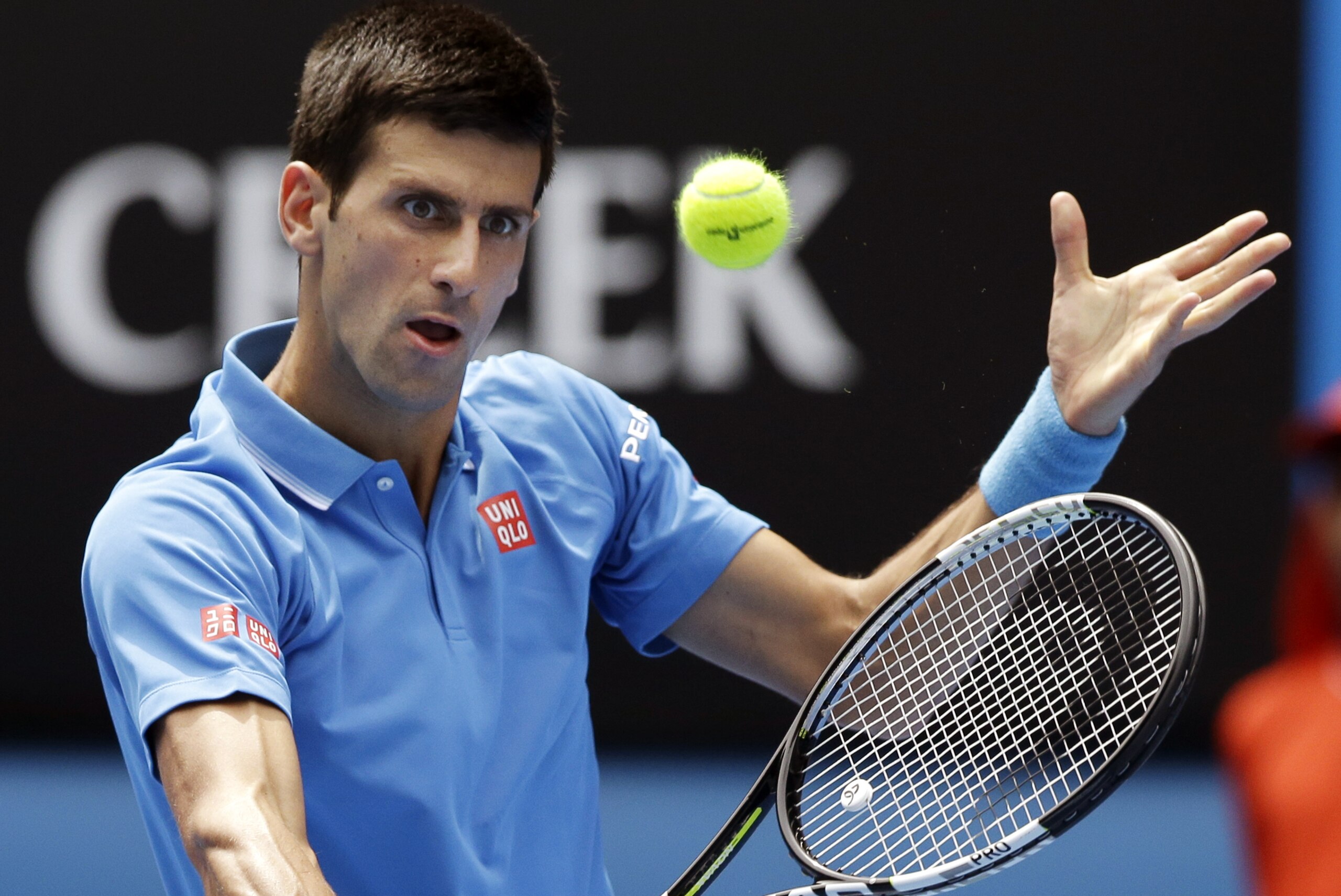 Novak Djokovic of Serbia makes backhand return to Slovenia’s Aljaz Bedene during their first round match at the Australian Open tennis championship in Melbourne, Australia, Tuesday, Jan. 20, 2015. (AP Photo/Lee Jin-man)
