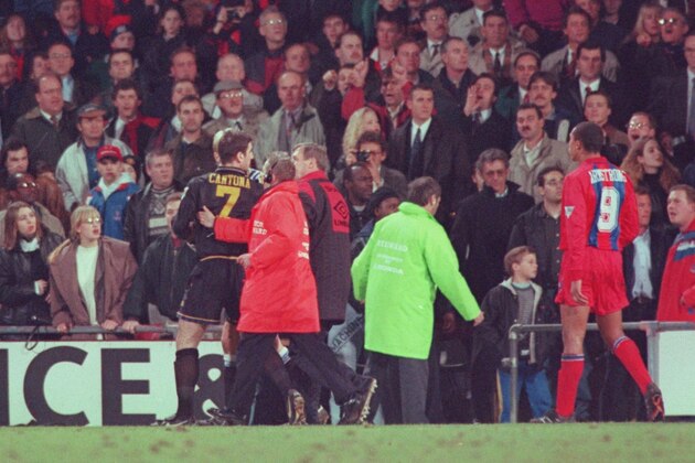 25 JAN 1995:  ERIC CANTONA OF MANCHESTER UNITED IS LED OFF THE PITCH AFTER FIGHTING WITH A FAN AFTER BEING SENT OFF DURING THE CRYSTAL PALACE V MANCHESTER UNITED MATCH AT SELHURST PARK. Mandatory Credit: Shaun Botterill/ALLSPORT