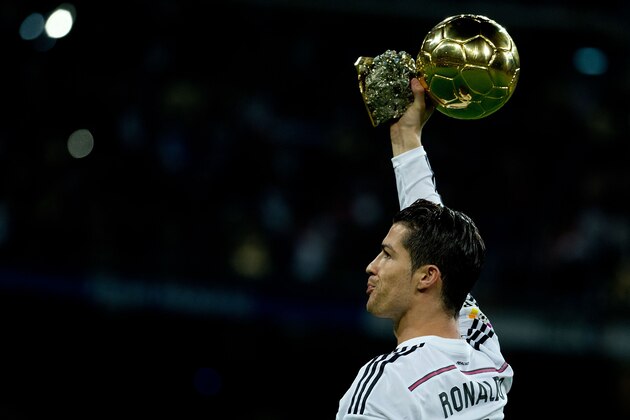 MADRID, SPAIN - JANUARY 15:  Cristiano Ronaldo of Real Madrid CF offers his third Golden Ball to the audience prior to start the Copa del Rey Round of 16  second leg match between Real Madrid CF and Club Atletico de Madrid at Estadio Santiago Bernabeu on January 15, 2015 in Madrid, Spain.  (Photo by Gonzalo Arroyo Moreno/Getty Images)