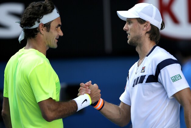 Andreas Seppi of Italy, right, is congratulated by Roger Federer of Switzerland after winning their third round match at the Australian Open tennis championship in Melbourne, Australia, Friday, Jan. 23, 2015. (AP Photo/Bernat Armangue)