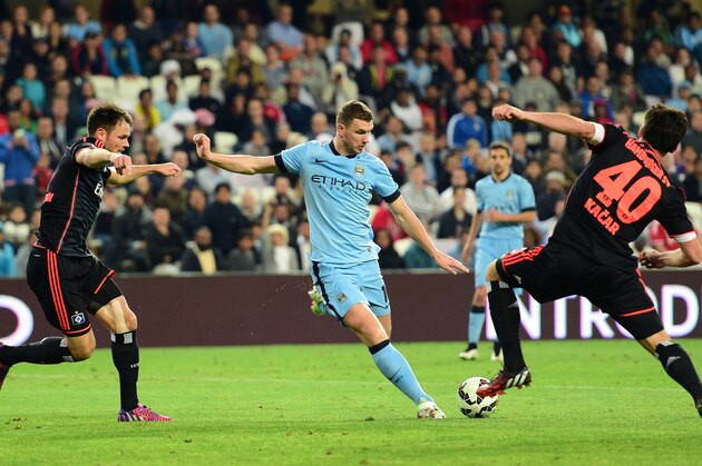 Manchester City's Bosnian striker Edin Dzeko, center, shoots the ball during a friendly match against Hamburg in Al Ain, United Arab Emirates, Wednesday, Jan. 21, 2015. (AP Photo/Said Khaled)