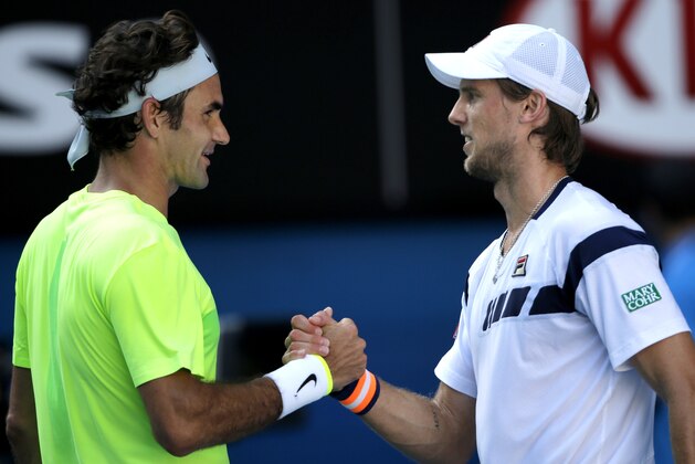 Andreas Seppi of Italy, right, is congratulated by Roger Federer of Switzerland after winning their third round match at the Australian Open tennis championship in Melbourne, Australia, Friday, Jan. 23, 2015. (AP Photo/Bernat Armangue)