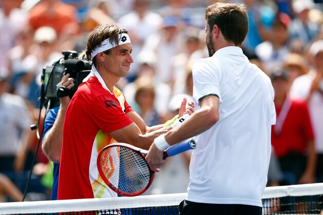 NEW YORK, NY - AUGUST 31:  Gilles Simon of France meets David Ferrer of Spain after winning their men's singles third round match on Day Seven of the 2014 US Open at the USTA Billie Jean King National Tennis Center on August 31, 2014 in the Flushing neighborhood of the Queens borough of New York City.  (Photo by Julian Finney/Getty Images)