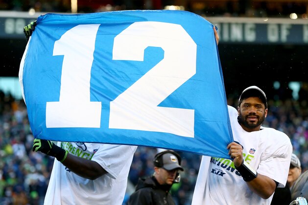 SEATTLE, WA - JANUARY 18: Russell Wilson #3 of the Seattle Seahawks waves the 12th Man flag after the Seahawks defeated the Green Bay Packers in the 2015 NFC Championship game at CenturyLink Field on January 18, 2015 in Seattle, Washington.  (Photo by Ronald Martinez/Getty Images)