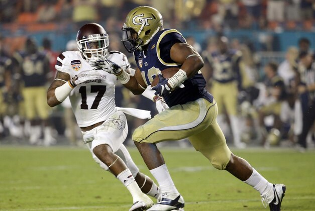 Georgia Tech running back Synjyn Days (10) runs for a touchdown as Mississippi State defensive back Deontay Evans (17) defends in the second half of the Orange Bowl NCAA college football game, Wednesday, Dec. 31, 2014, in Miami Gardens, Fla. (AP Photo/Lynne Sladky)
