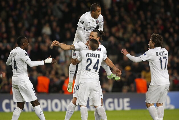 PSG's Zlatan Ibrahimovic, center, celebrates after scoring the opening goal with his teammates during a Group F Champions League soccer match between FC Barcelona and PSG at the Camp Nou stadium in Barcelona, Spain, Wednesday Dec. 10, 2014. (AP Photo/Emilio Morenatti)