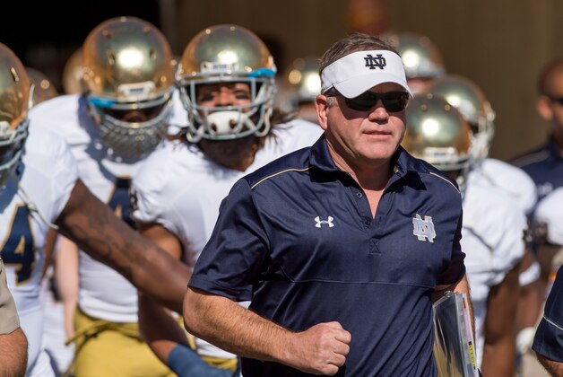 Nov 8, 2014; Tempe, AZ, USA; Notre Dame Fighting Irish head coach Brian Kelly leads his players onto the field for the game against the Arizona State Sun Devils at Sun Devil Stadium. Mandatory Credit: Matt Cashore-USA TODAY Sports