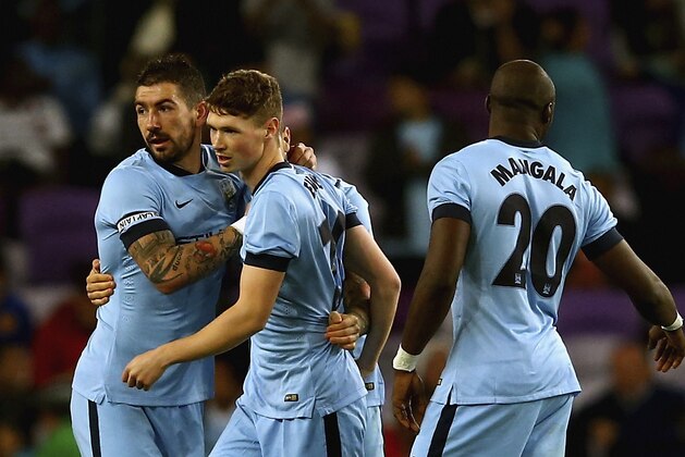 AL AIN, UNITED ARAB EMIRATES - JANUARY 21: George Evans of Manchester City celebrates with teammates after scoring their second goal during the friendly match between Hamburg SV and Manchester City at Hazza bin Zayed Stadium on January 21, 2015 in Al Ain, United Arab Emirates.  (Photo by Francois Nel/Getty Images)