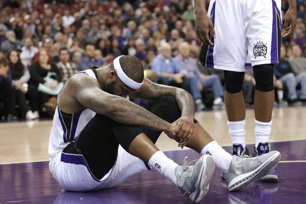 Sacramento Kings center DeMarcus Cousins sits on the court after going to the floor in a scramble for the ball during the fourth quarter of an NBA basketball game against the Brooklyn Nets in Sacramento, Calif., Wednesday, Jan. 21, 2015. The Nets won 103-100. (AP Photo/Rich Pedroncelli)