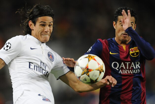PSG's Edinson Cavani, left, and Barcelona's Pedro Rodriguez challenges for the ball during the Group F Champions League soccer match between FC Barcelona and PSG at the Camp Nou stadium in Barcelona, Spain, Wednesday Dec. 10, 2014. (AP Photo/Manu Fernandez)