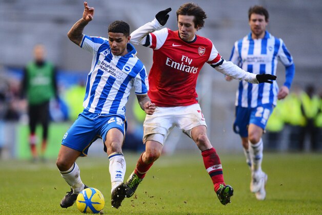 BRIGHTON, ENGLAND - JANUARY 26:  Liam Bridcutt of Brighton & Hove Albion holds off Tomas Rosicky of Arsenal during the FA Cup with Budweiser Fourth Round match between Brighton & Hove Albion and Arsenal at Amex Stadium on January 26, 2013 in Brighton, England.  (Photo by Mike Hewitt/Getty Images)