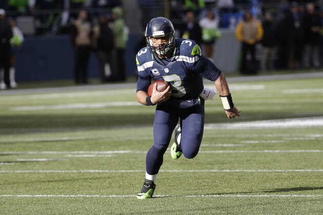 Seattle Seahawks quarterback Russell Wilson (3) runs against the Green Bay Packers during the first half of the NFL football NFC Championship game Sunday, Jan. 18, 2015, in Seattle. (AP Photo/David J. Phillip)