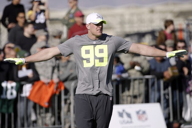 Houston Texans' J.J. Watt stretches during a practice session at Luke Air Force Base for the NFL Football Pro Bowl Thursday, Jan. 22, 2015, in Glendale, Ariz. (AP Photo/David J. Phillip)