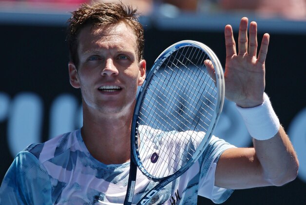 Tomas Berdych of the Czech Republic waves after defeating Viktor Troicki of Serbia during their third round match at the Australian Open tennis championship in Melbourne, Australia, Friday, Jan. 23, 2015. (AP Photo/Rob Griffith)
