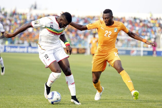 Ivory Coast’s Serge Wilfried Kanon, right, is challenged by Mali's Bakary Sako during their African Cup of Nations Group D soccer match at  the Estadio De Malabo in Malabo, Equatorial Guinea, Saturday, Jan. 24, 2015. (AP Photo/Sunday Alamba)