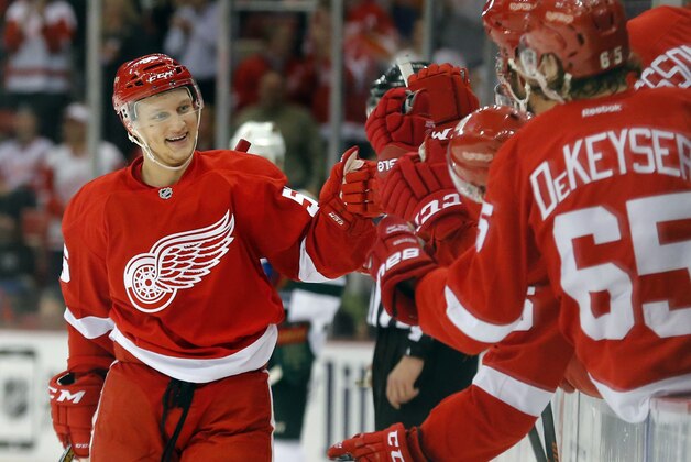 Detroit Red Wings left wing Teemu Pulkkinen (56) celebrates his goal against the Minnesota Wild in the first period of an NHL hockey game in Detroit Tuesday, Jan. 20, 2015. (AP Photo/Paul Sancya)
