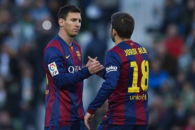 ELCHE, SPAIN - JANUARY 24:  Lionel Messi of Barcelona greets to teammate Jordi Alba during the La Liga match between Elche FC and FC Barcelona at Estadio Manuel Martinez Valero on January 24, 2015 in Elche, Spain.  (Photo by Manuel Queimadelos Alonso/Getty Images)