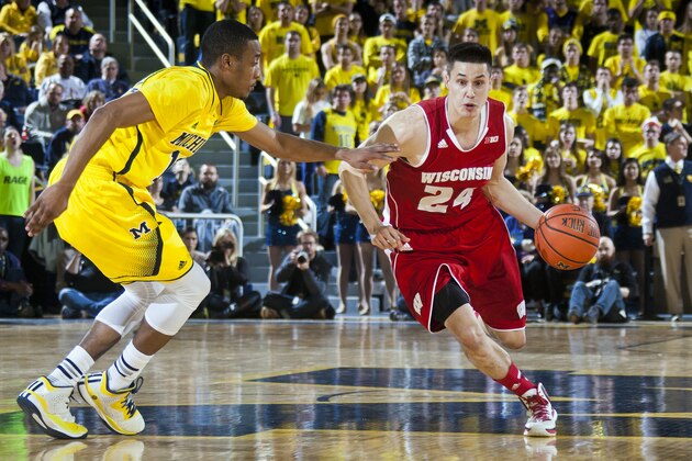 Michigan guard Muhammad-Ali Abdur-Rahkman defends Wisconsin guard Bronson Koenig (24) during the first half of an NCAA college basketball game in Ann Arbor, Mich., Saturday, Jan. 24, 2015. (AP Photo/Tony Ding)