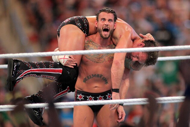 FILE - In this April 1, 2012, file photo, CM Punk competes against Chris Jericho at WrestleMania XXVIII in Sun Life Stadium in Miami Gardens, Fla. At 36, Punk is refreshed, focused and confident he can make the gutsy transition from the big stage(d) fighting of pro wrestling to a mixed martial arts career inside the cage for Ultimate Fighting Championship. (AP Photo/AP Images for Wreslemania, Marc Serota, File)