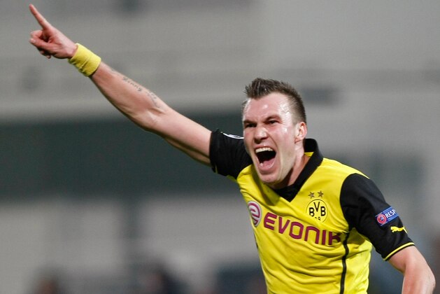 Dortmund's Kevin Grosskreutz celebrates his side's 2nd goal during the Group F Champions League soccer match between Olympique Marseille and Borussia Dortmund at the Velodrome stadium in Marseille, Southern France, Wednesday, Dec. 11, 2013. (AP Photo/Claude Paris)