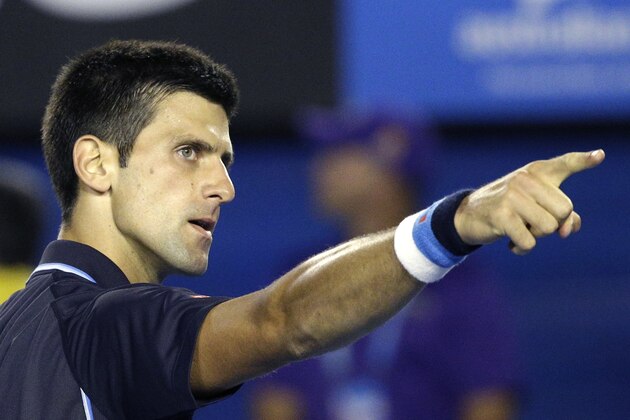 Novak Djokovic of Serbia points to his team after winning over Fernando Verdasco of Spain in their third round match at the Australian Open tennis championship in Melbourne, Australia, Saturday, Jan. 24, 2015. (AP Photo/Lee Jin-man)
