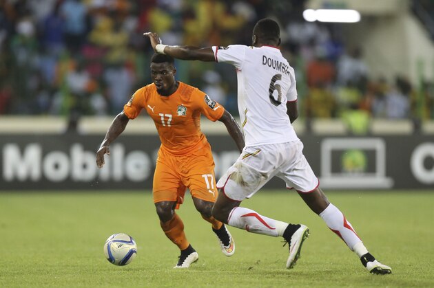 Ivory Coast’s Serge Aurier, left, is challenged by Mali's Tongo Doumbia during their African Cup of Nations Group D soccer match in Malabo, Equatorial Guinea, Saturday, Jan. 24, 2015. (AP Photo/Sunday Alamba)
