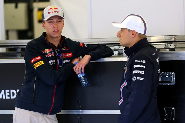 NORTHAMPTON, ENGLAND - JULY 06:  Daniil Kvyat of Russia and Scuderia Toro Rosso speaks with Valtteri Bottas of Finland and Williams before the drivers' parade ahead of the British Formula One Grand Prix at Silverstone Circuit on July 6, 2014 in Northampton, United Kingdom.  (Photo by Mark Thompson/Getty Images)