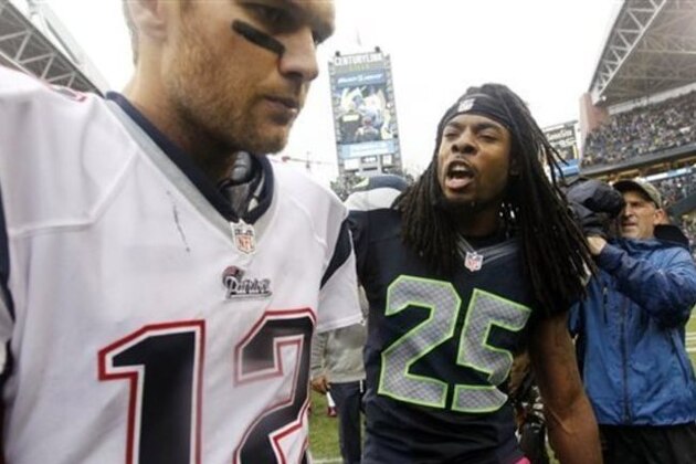 FILE - In this Oct. 14, 2014, file photo, Seattle Seahawks' Richard Sherman (25) talks with New England Patriots quarterback Tom Brady after the Seahawks won 24-23 in an NFL football game in Seattle. Sherman already gave Brady an earful the last time the Seahawks played the Patriots. This Super Bowl could feature some epic yapping from some of the best trash-talkers in the NFL. (AP Photo/Elaine Thompson)