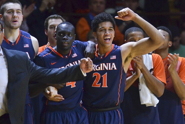 Jan 25, 2015; Blacksburg, VA, USA; Virginia Cavaliers forward Isaiah Wilkins (21) and guard Marial Shayok (4) react on the bench during the closing second of their victory against the Virginia Tech Hokies at Cassell Coliseum. Virginia defeated Virginia Tech 50-47. Mandatory Credit: Michael Shroyer-USA TODAY Sports