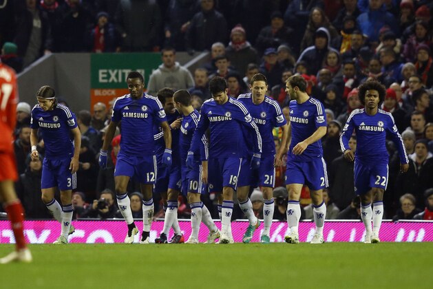 Chelsea's Eden Hazard, center, celebrates his goal with teammates during the English League Cup semi-final first leg soccer match between Liverpool and Chelsea at Anfield Stadium, Liverpool, England, Tuesday Jan. 20, 2015. (AP Photo/Jon Super)