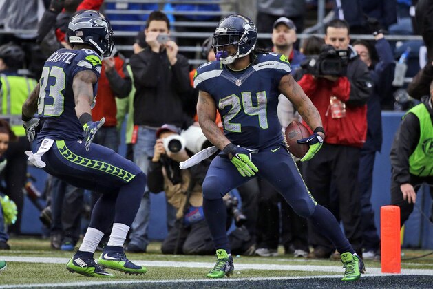 Seattle Seahawks' Marshawn Lynch (24) celebrates his touchdown run during the second half of the NFL football NFC Championship game against the Green Bay Packers Sunday, Jan. 18, 2015, in Seattle. (AP Photo/Elaine Thompson)