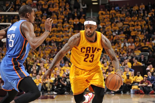 CLEVELAND, OH - JANUARY 25:  LeBron James #23 of the Cleveland Cavaliers handles the ball against Kevin Durant #35 of the Oklahoma City Thunder during the game on January 25, 2015 at Quicken Loans Arena in Cleveland, Ohio. NOTE TO USER: User expressly acknowledges and agrees that, by downloading and/or using this Photograph, user is consenting to the terms and conditions of the Getty Images License Agreement. Mandatory Copyright Notice: Copyright 2015 NBAE (Photo by Bill Baptist/NBAE via Getty Images)