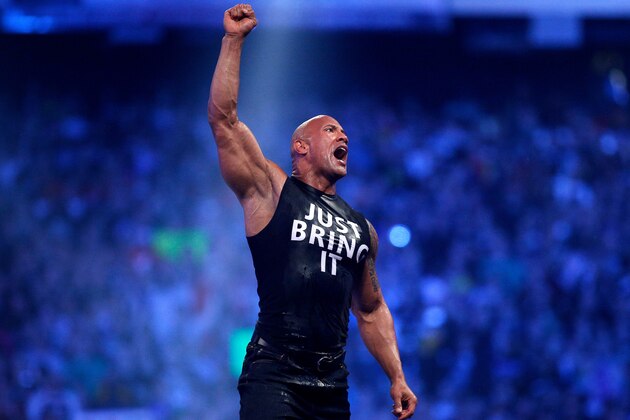 Dwayne Johnson aka The Rock reacts during Wrestlemania XXX at the Mercedes-Benz Super Dome in New Orleans on Sunday, April 6, 2014. (Jonathan Bachman/AP Images for WWE)