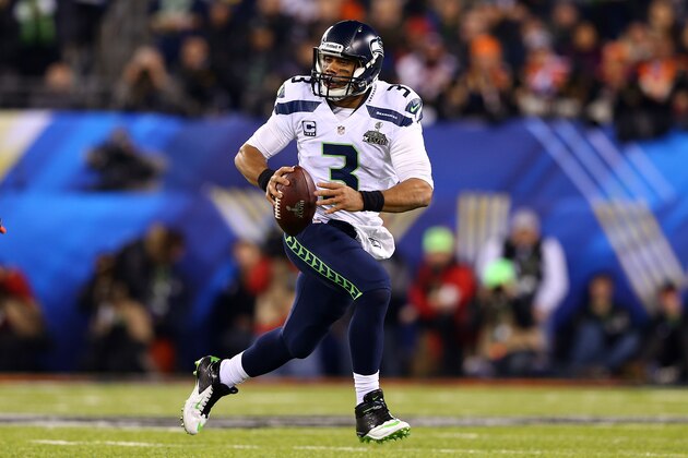 EAST RUTHERFORD, NJ - FEBRUARY 02:  Quarterback Russell Wilson #3 of the Seattle Seahawks scrambles against the Denver Broncos during Super Bowl XLVIII at MetLife Stadium on February 2, 2014 in East Rutherford, New Jersey.  (Photo by Elsa/Getty Images)