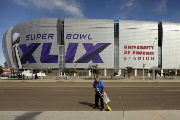A worker sweeps outside the University of Phoenix Stadium before the Pro Bowl Sunday, Jan. 25, 2015, in Glendale, Ariz. The venue will also host Super Bowl XLIX between the New England Patriots and the Seattle Seahawks on Sunday, Feb. 1, 2015. (AP Photo/Charlie Riedel)