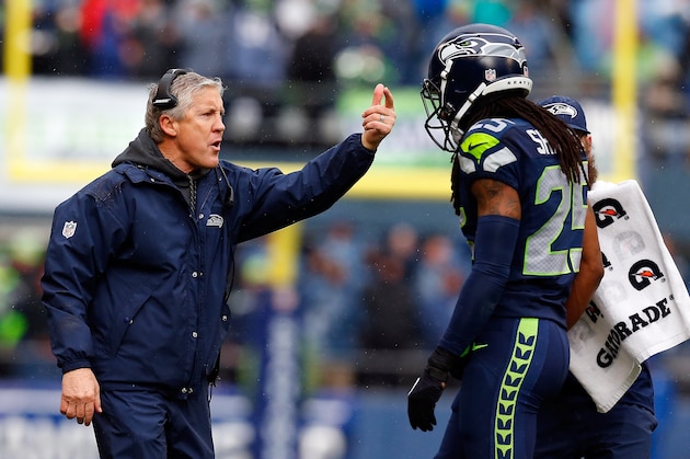 SEATTLE, WA - JANUARY 18:  Richard Sherman #25 speaks with head coach Pete Carroll of the Seattle Seahawks against the Green Bay Packers during the 2015 NFC Championship game at CenturyLink Field on January 18, 2015 in Seattle, Washington.  (Photo by Tom Pennington/Getty Images)