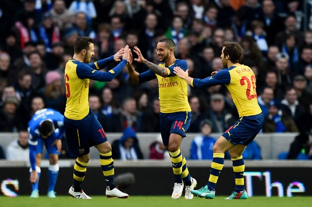 BRIGHTON, ENGLAND - JANUARY 25:  Theo Walcott of Arsenal celebrates with team-mates Aaron Ramsey and Mathieu Flamini after scoring the opening goal during the FA Cup Fourth Round match between Brighton & Hove Albion and Arsenal at Amex Stadium on January 25, 2015 in Brighton, England.  (Photo by Mike Hewitt/Getty Images)