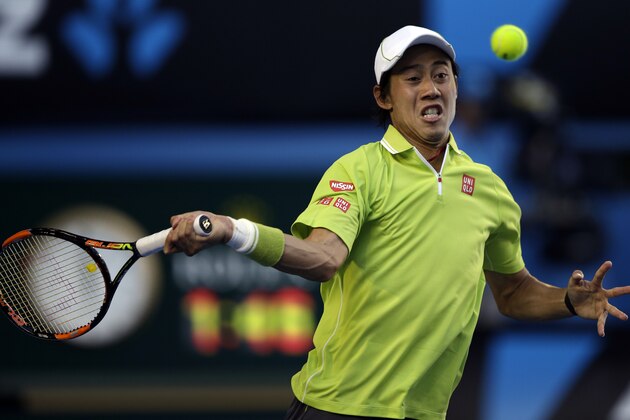 Kei Nishikori of Japan makes a forehand return to David Ferrer of Spain during their fourth round match at the Australian Open tennis championship in Melbourne, Australia, Monday, Jan. 26, 2015. (AP Photo/Lee Jin-man)