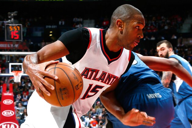 ATLANTA, GA - JANUARY 25:  Al Horford #15 of the Atlanta Hawks draws a foul as he drives against Thaddeus Young #33 of the Minnesota Timberwolves at Philips Arena on January 25, 2015 in Atlanta, Georgia.  NOTE TO USER: User expressly acknowledges and agrees that, by downloading and or using this photograph, User is consenting to the terms and conditions of the Getty Images License Agreement.  (Photo by Kevin C. Cox/Getty Images)