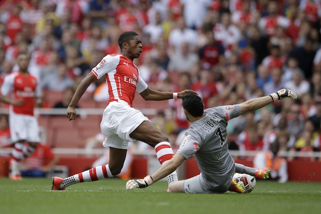 Arsenal's Chuba Akpom, left, is brought down by goalkeeper Danijel Subasic, right, during the Emirates Cup soccer match between Arsenal and AS Monaco at Arsenal's Emirates Stadium in London, Sunday, Aug. 3, 2014.  (AP Photo/Matt Dunham)