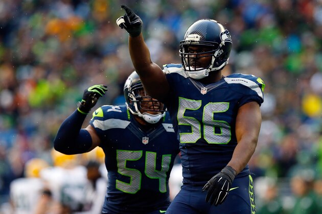 SEATTLE, WA - JANUARY 18:  Cliff Avril #56 and Bobby Wagner #54 of the Seattle Seahawks react during the third quarter of the 2015 NFC Championship game against the Green Bay Packers at CenturyLink Field on January 18, 2015 in Seattle, Washington.  (Photo by Tom Pennington/Getty Images)
