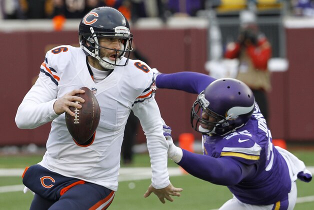 Chicago Bears quarterback Jay Cutler runs from Minnesota Vikings defensive tackle Tom Johnson, right, during the second half of an NFL football game, Sunday, Dec. 28, 2014, in Minneapolis. The Vikings won 13-9. (AP Photo/Ann Heisenfelt)