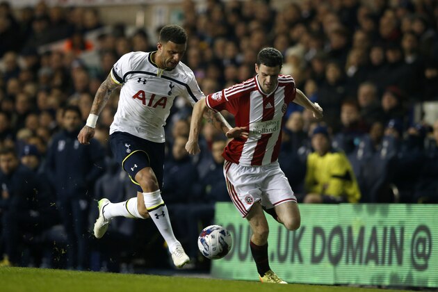 Tottenham’s Kyle Walker, left vies for the ball with Sheffield United’s James Murphy during their English League Cup semifinal 1st leg soccer match between Tottenham Hotspur and Sheffield United, at the White Hart Lane stadium in London, Wednesday, Jan  21,  2015. (AP Photo/Alastair Grant)